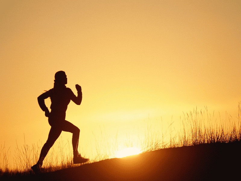 a woman running a hill sprint